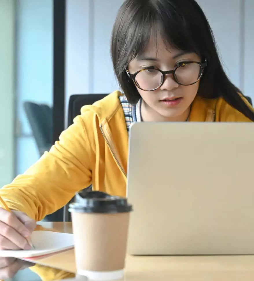 a female student with glasses is lacquer a lesson K5U3XL7